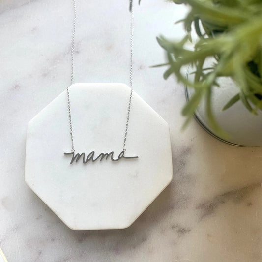 a silver necklace with the word "mama"